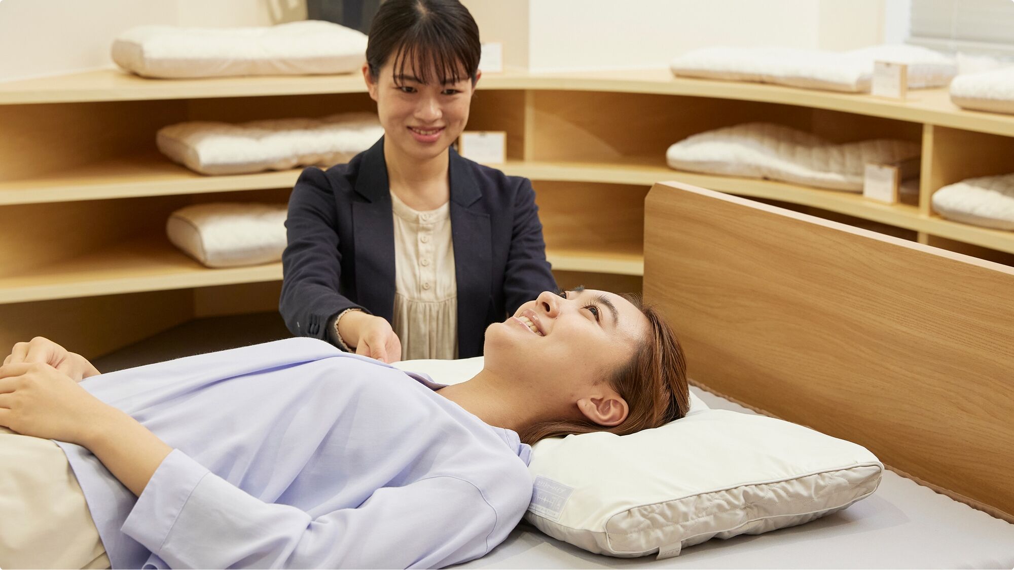 A staff member adjusting the pillow height for a reclining customer